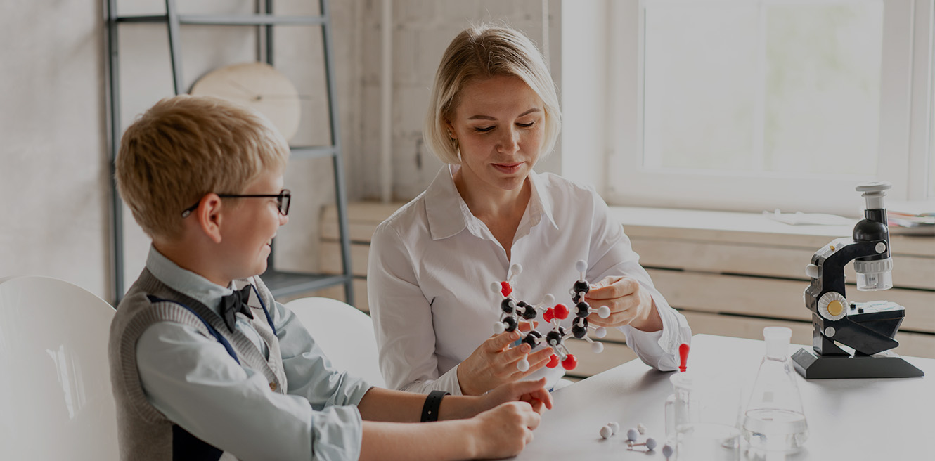 Female science tutor in Portland studying chemistry with student